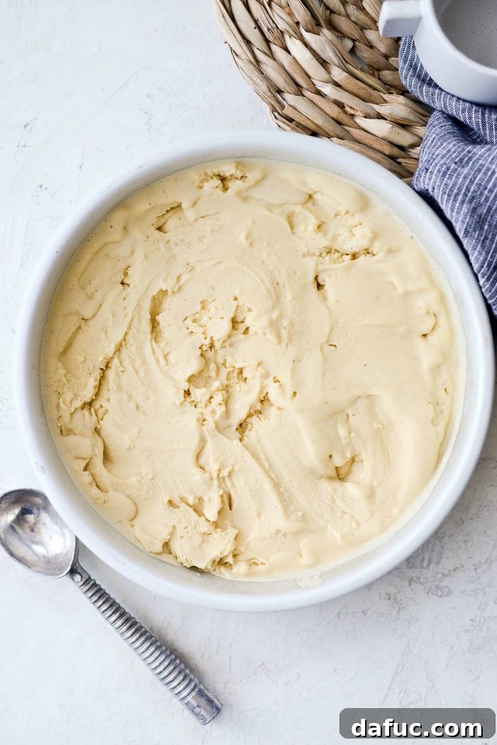 Golden Brown Butter Indulgence 25 Close-up of brown butter ice cream being smoothed in a container for freezing.