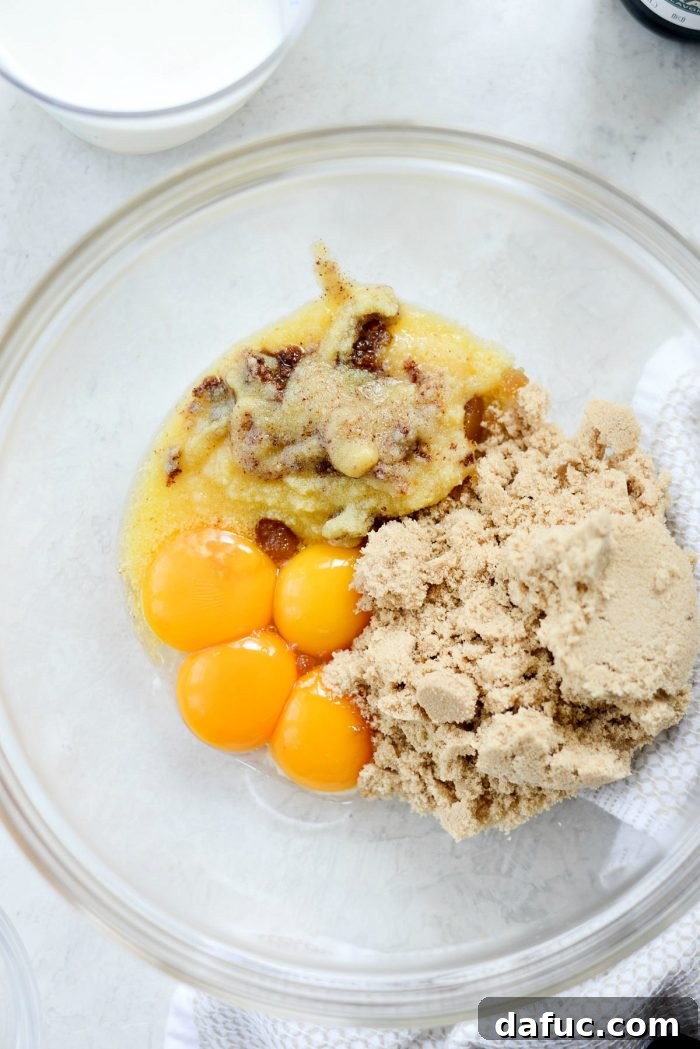 Golden Brown Butter Indulgence 6 Cooled brown butter, egg yolks, and brown sugar in a bowl, ready to be whisked.