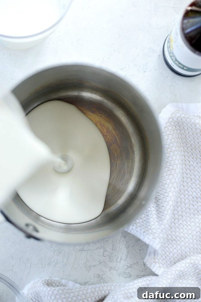 Golden Brown Butter Indulgence 8 Heavy cream and whole milk heating in a saucepan on the stovetop.