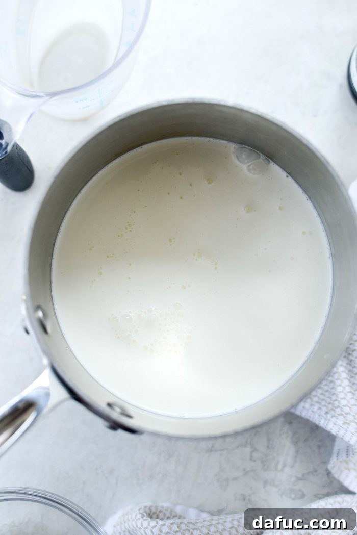 Golden Brown Butter Indulgence 9 Stirring the heavy cream and whole milk in a saucepan as it simmers.