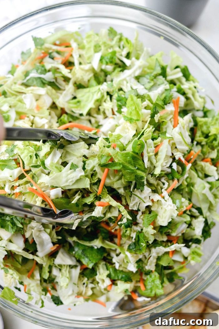 Mixing chopped vegetables for Asian Cabbage Chopped Salad