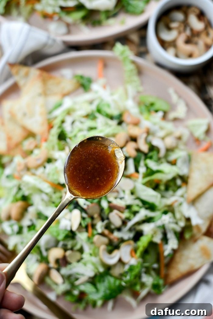Tossing Asian Chopped Salad with tongs