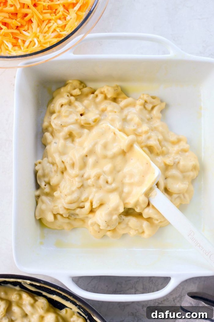 Tossing Macaroni in Creamy Cheese Sauce with a Spatula
