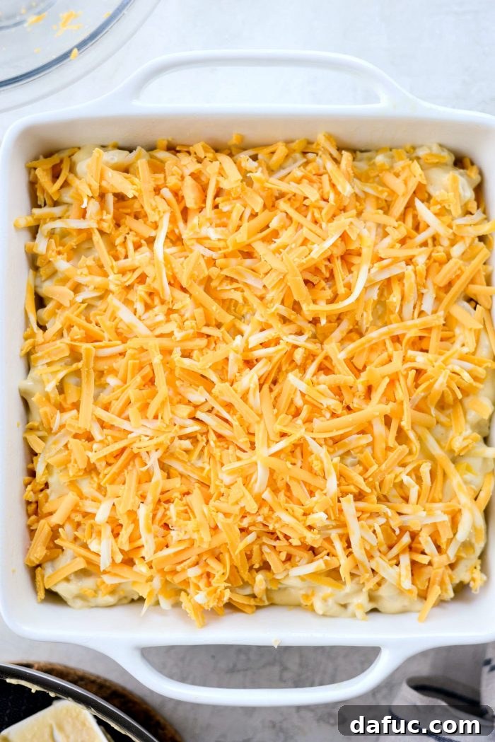 Layering Half of the Macaroni and Cheese into a Casserole Dish