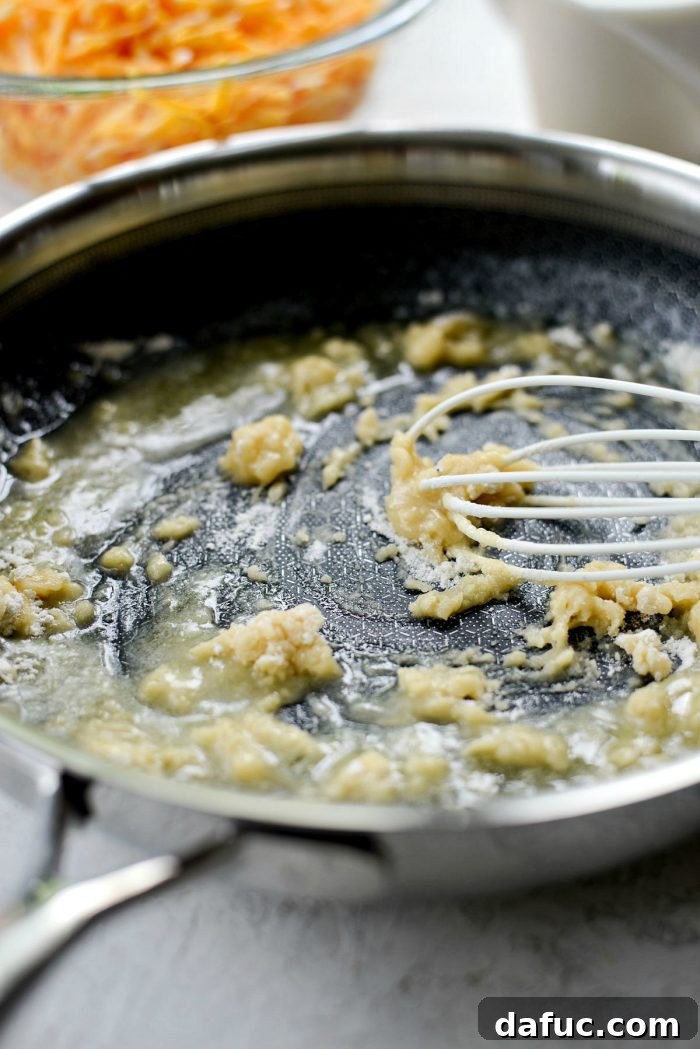 Sprinkling Flour into Melted Butter to Create a Roux for Mac and Cheese
