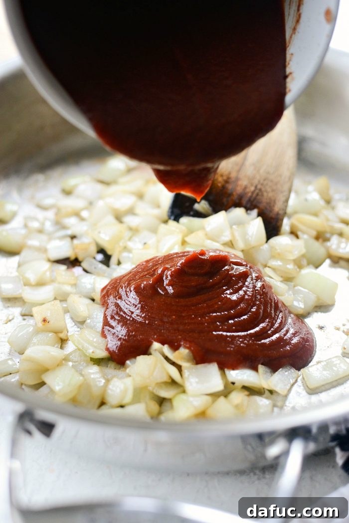 Adding the prepared sauce to the sautéed onions