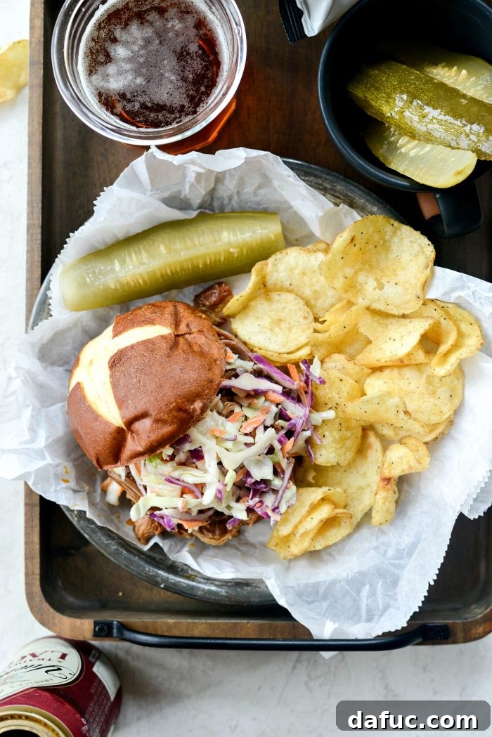 Deliciously tender shredded pork topped with barbecue sauce meets crisp coleslaw and pretzel bun.