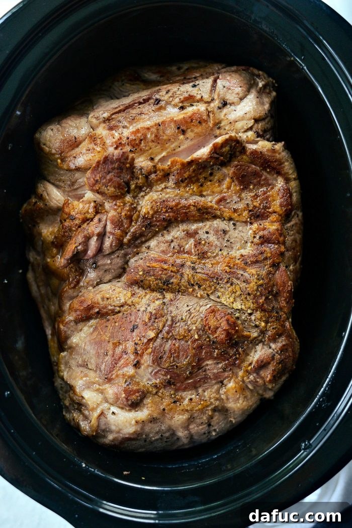 Seared pork shoulder transferred to the slow cooker