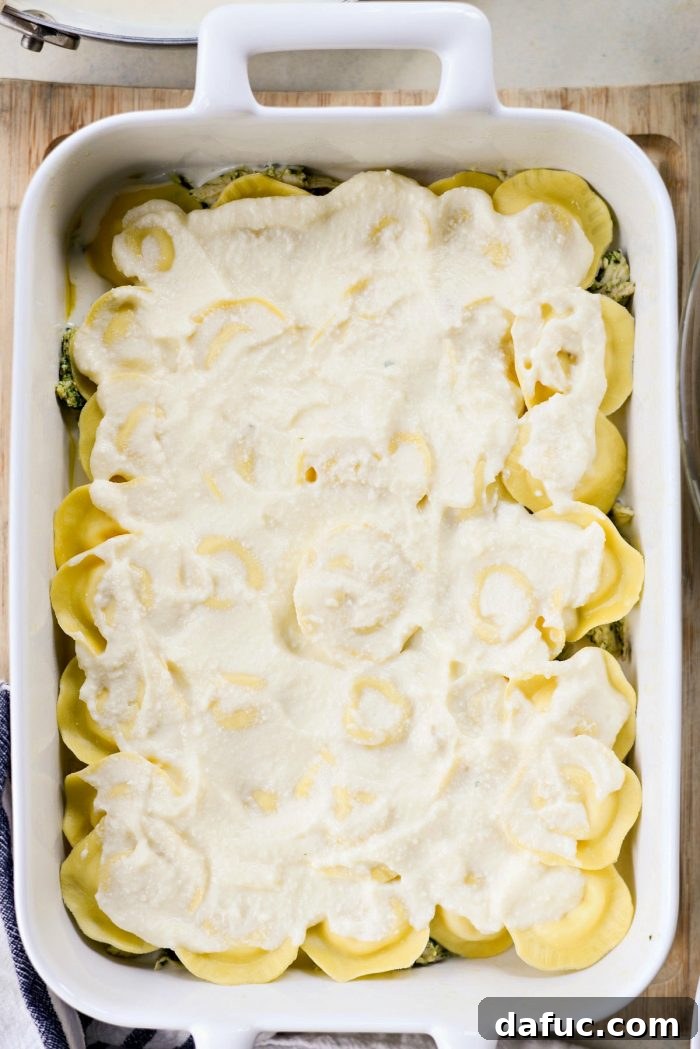 Pesto Chicken Ravioli Lasagna Bake 12 Half of the raviolis arranged in an even layer