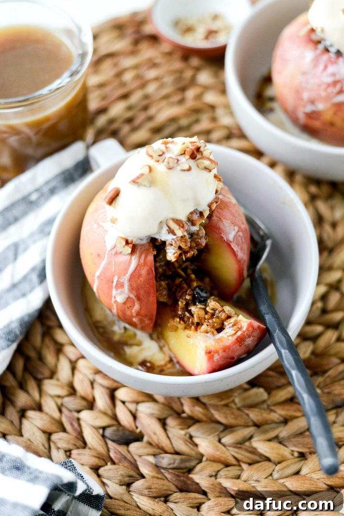 Baked Apples served with vanilla ice cream, butter rum sauce, and pecans
