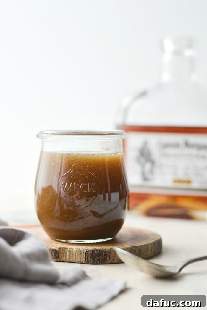 Close-up of freshly made Homemade Butter Rum Sauce in a saucepan, highlighting its smooth, glossy finish.