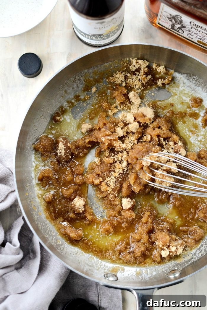 Melting unsalted butter in a deep-sided skillet over low heat for the butter rum sauce recipe.