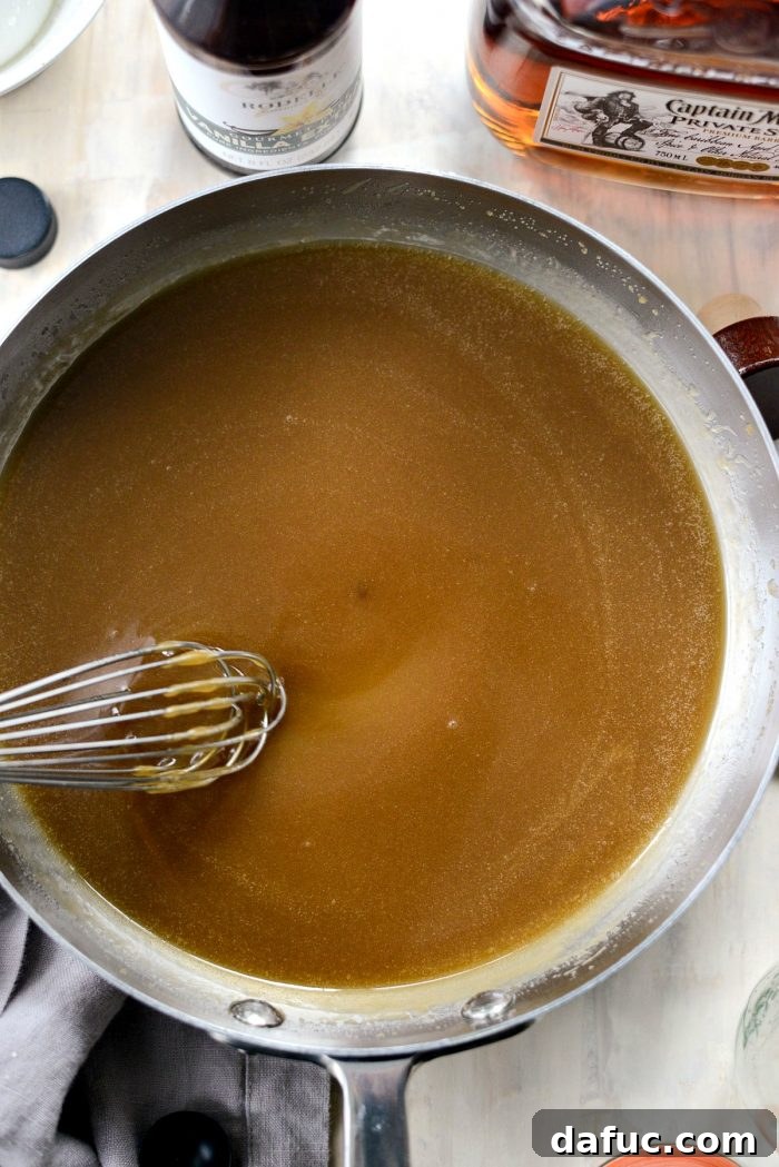 Sprinkling flaky sea salt over the finished Homemade Butter Rum Sauce for a delightful salted caramel variation.