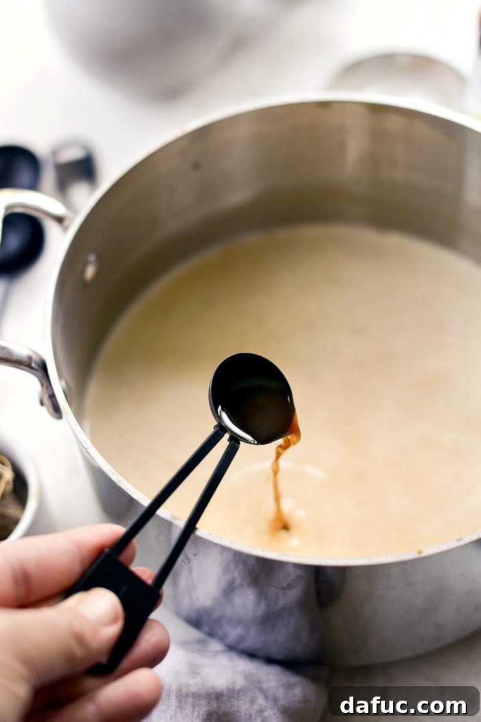 Cozy Pumpkin Chai Dream 11 Vanilla extract being added to the chai latte mixture