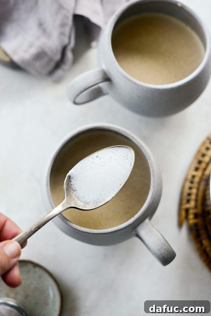 Cozy Pumpkin Chai Dream 15 Spoonful of frothy milk being added to a Pumpkin Spice Chai Latte
