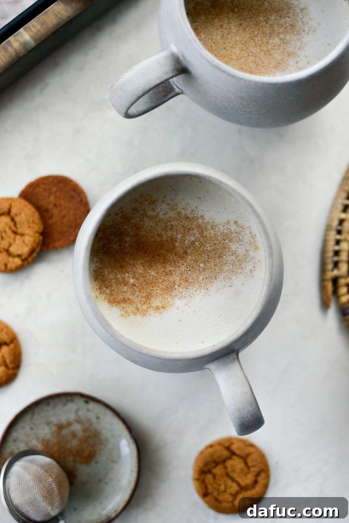Cozy Pumpkin Chai Dream 16 Pumpkin Spice Chai Latte topped with frothed milk and a dusting of spice