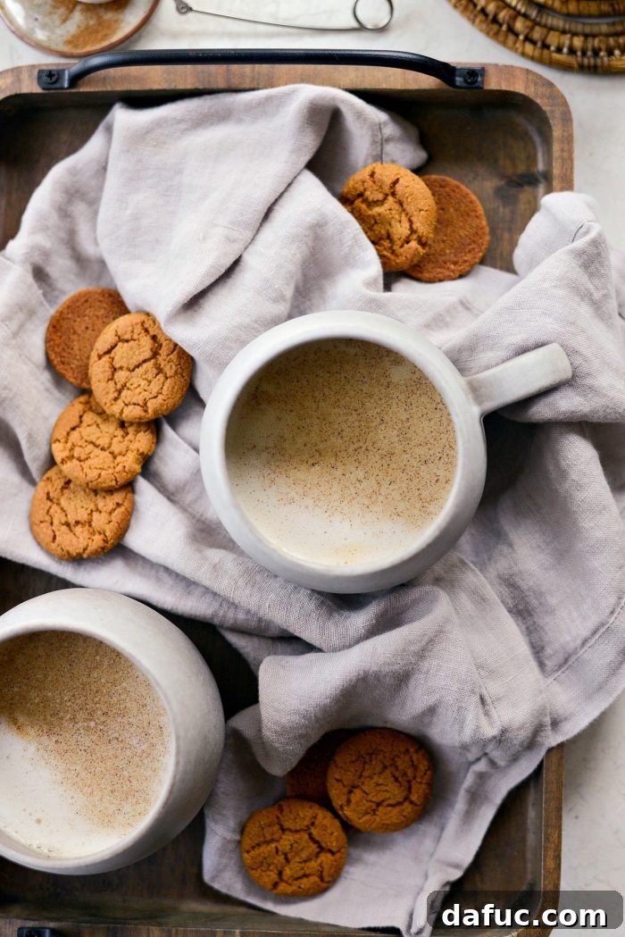 Cozy Pumpkin Chai Dream 18 Pumpkin Spice Chai Latte garnished with a sprinkle of spice