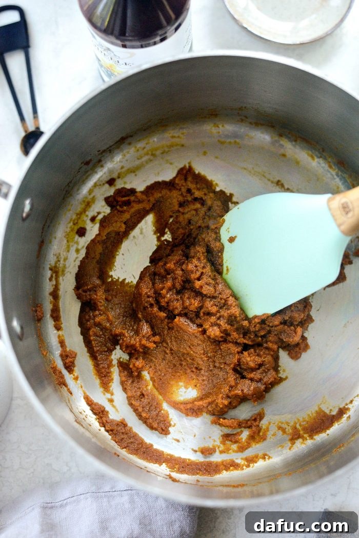 Cozy Pumpkin Chai Dream 6 Stirring pumpkin puree with brown sugar and pumpkin spice in a pan
