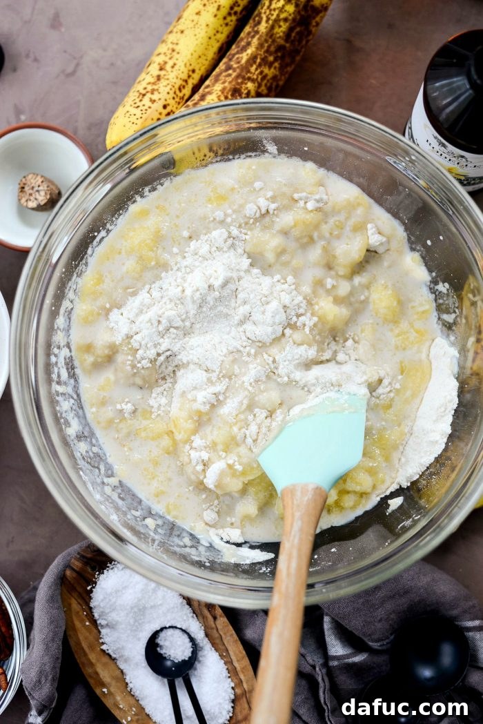 Golden Maple Bourbon Banana Pudding Cake 12 Stirring wet ingredients for banana cake