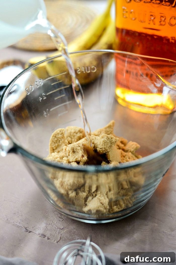 Golden Maple Bourbon Banana Pudding Cake 15 Transferring banana cake batter to baking dish