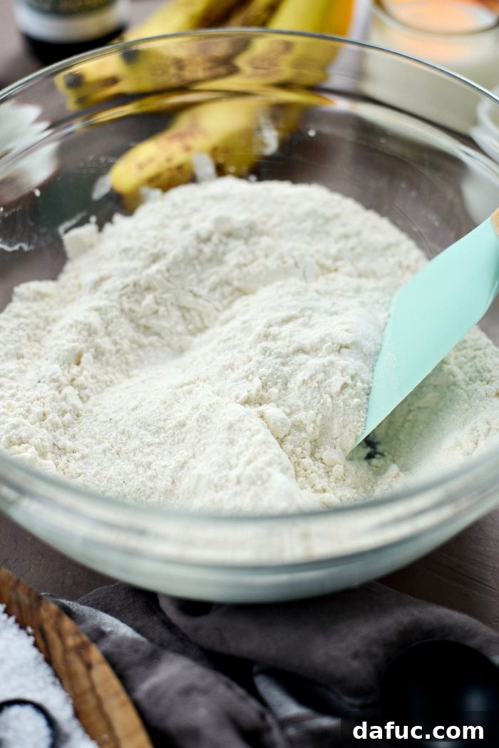 Golden Maple Bourbon Banana Pudding Cake 6 Mixing dry ingredients for the banana cake batter