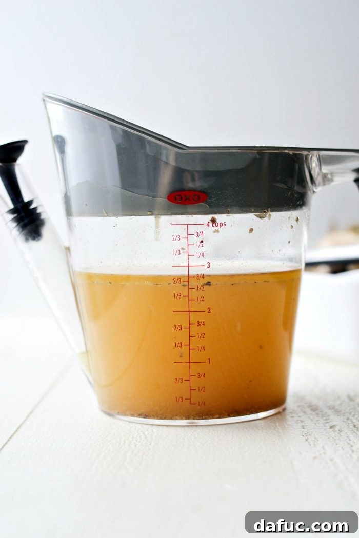Cooked chicken removed from slow cooker for shredding