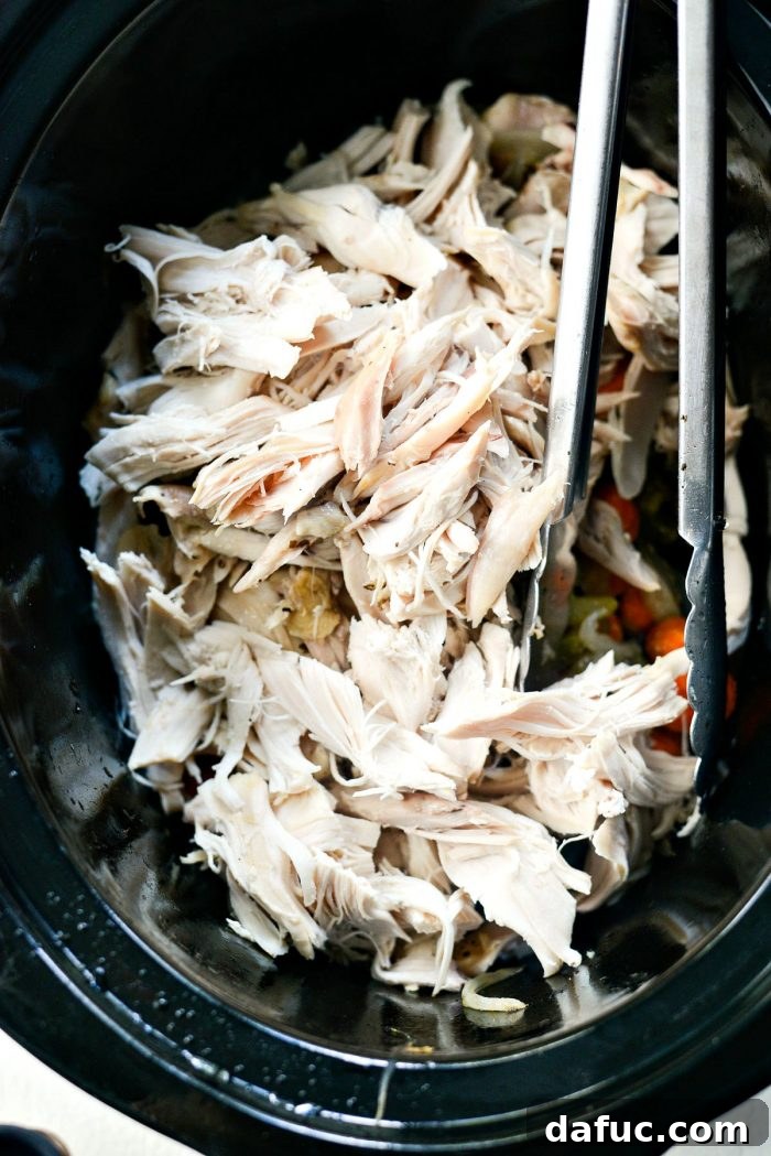 Shredded chicken added back to vegetables in slow cooker
