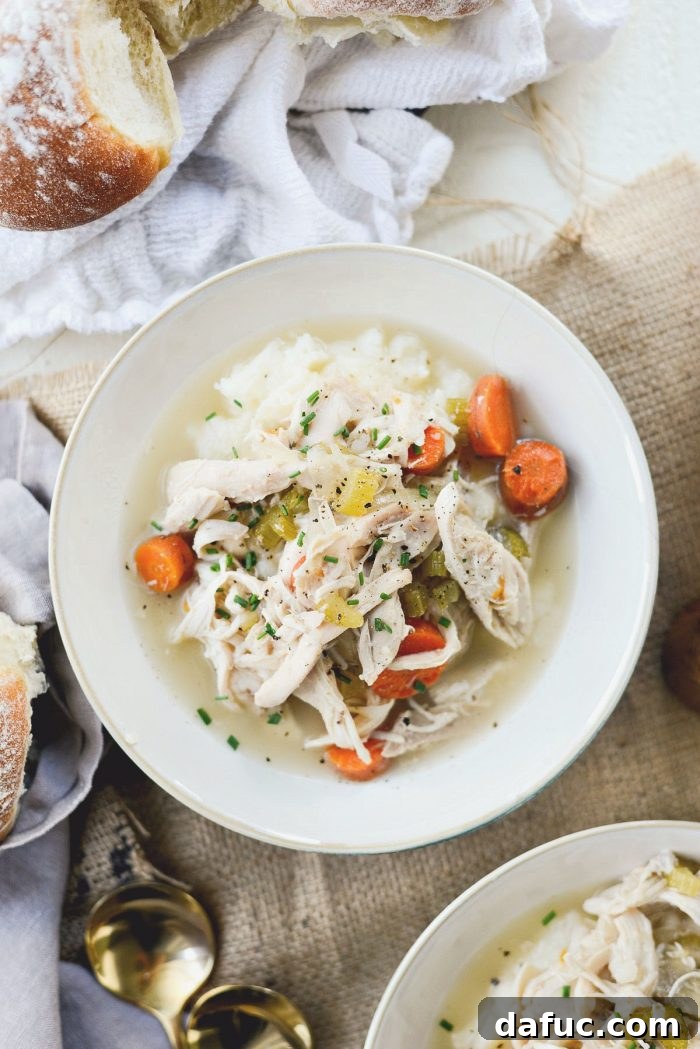 Serving slow cooker chicken and vegetables with mashed potatoes
