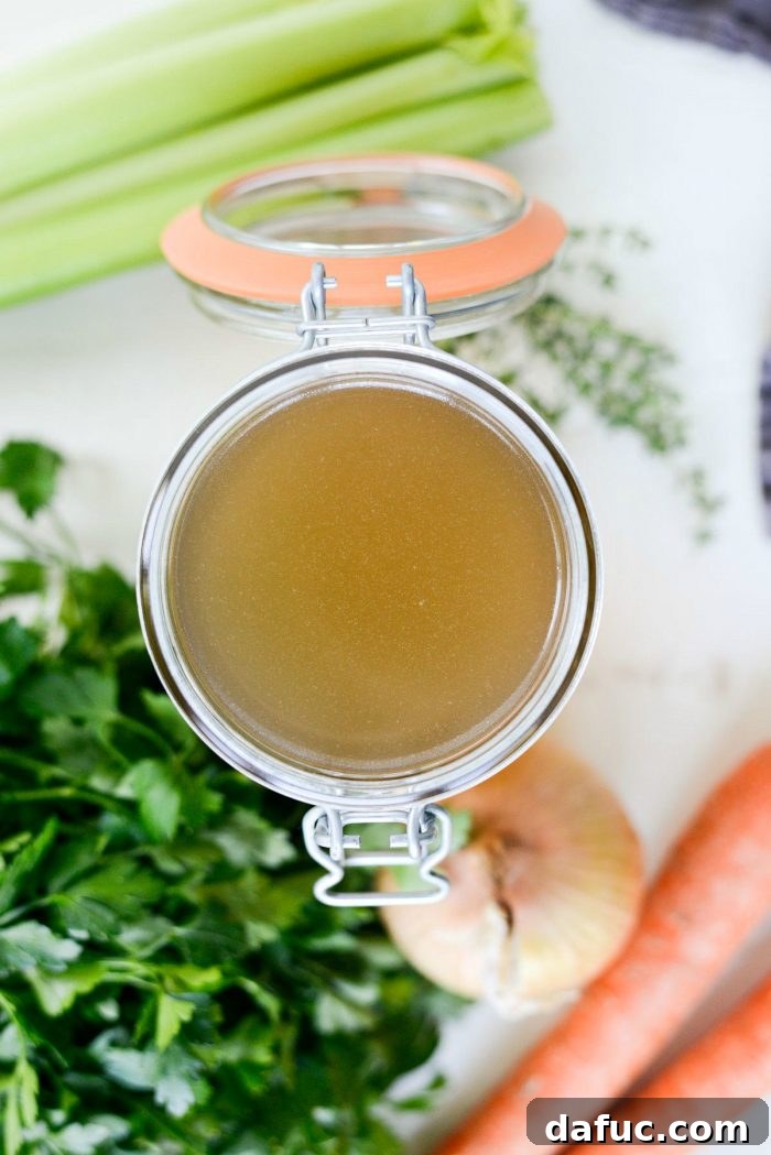 Low & Slow Chicken Broth 3 Close-up of chicken bones, carrots, onions, and celery ready for slow cooker chicken stock, highlighting fresh ingredients. #ingredients #slowcookerstock #freshcooking #kitchenbasics