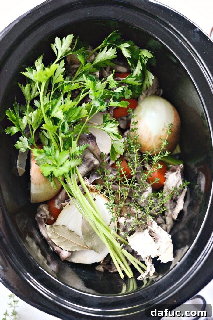 Deeply Flavored Slow Cooker Chicken Broth 6 Adding herbs to slow cooker chicken stock