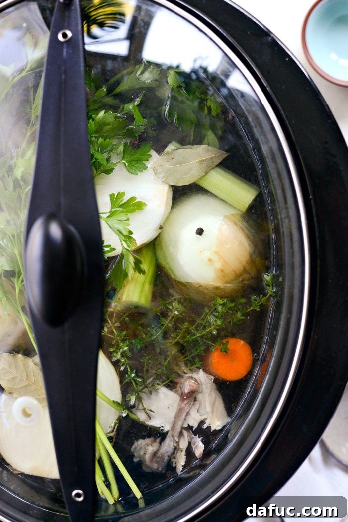 Low & Slow Chicken Broth 10 Slow cooker covered and set to cook, illustrating the convenience of the 'set it and forget it' method for chicken stock. #slowcookercooking #homemadegoodness #longsimmer