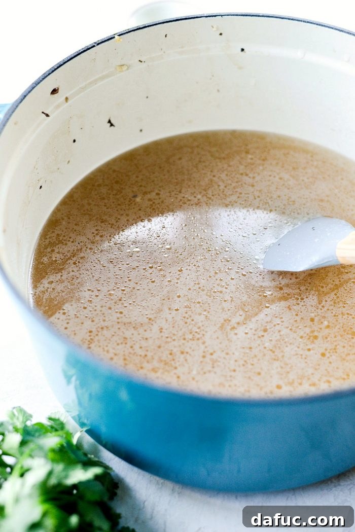 Rich Vegetable Broth Simmering in Dutch Oven for Ramen - SimplyScratch.com Homemade Broth Recipe