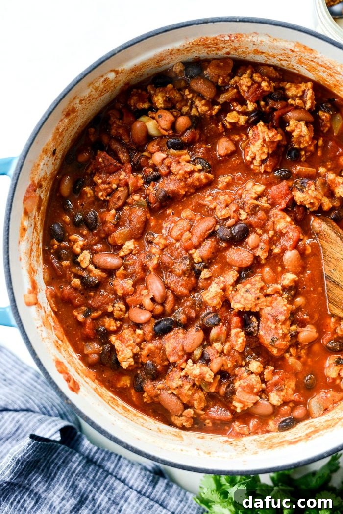 Southwest Three Bean Chicken Chili simmering gently in a Dutch oven