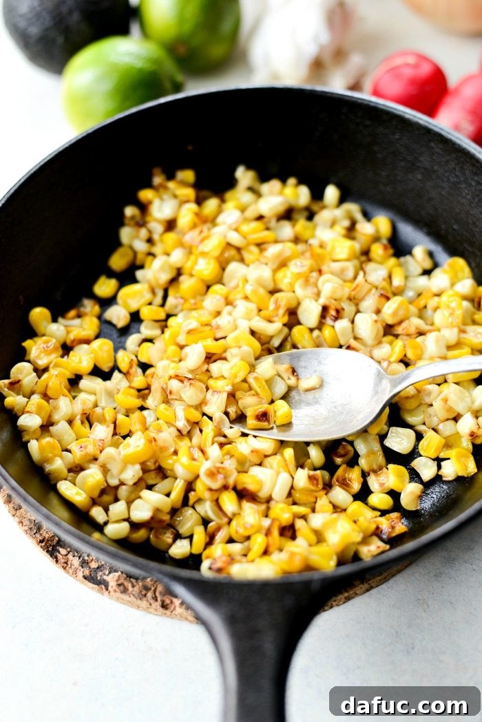 Preparing fresh toppings while the chili simmers, including charred corn