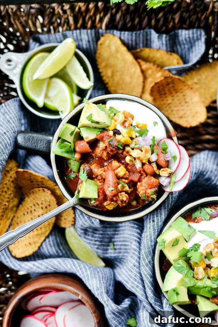 Close-up of a serving of Southwest Three Bean Chicken Chili with toppings