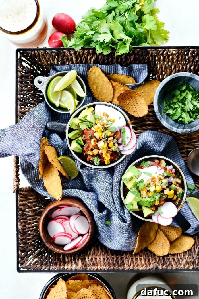 Close-up of hearty Southwest Three Bean Chicken Chili with a colorful array of toppings