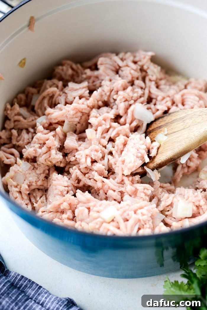 Browning lean ground chicken in a Dutch oven for chili