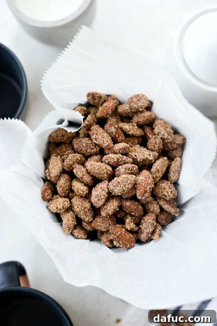 Irresistible Cinnamon Sugar Almonds 14 Finished cinnamon sugar almonds cooling on a baking sheet, showcasing their golden, crunchy coating.