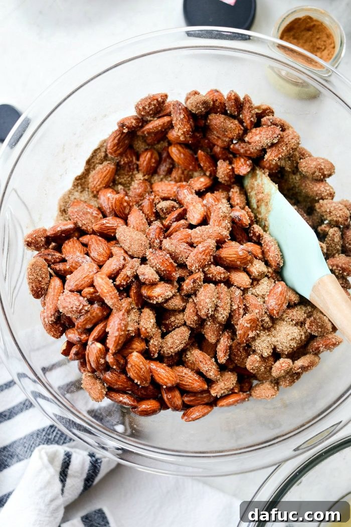 Irresistible Cinnamon Sugar Almonds 9 Raw almonds being tossed in the foamy egg white and vanilla mixture to ensure even coating.