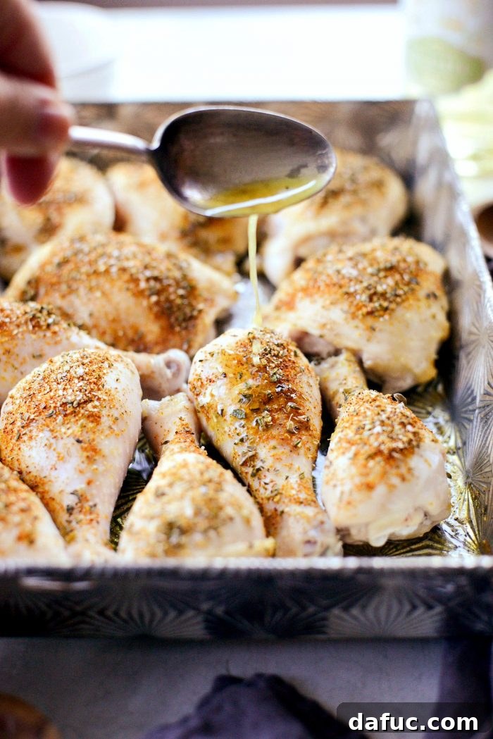 Crispy Garlic Parmesan Baked Chicken 7 Chicken baking in the oven, showing the skin starting to crisp and brown. Essential step for Parmesan Garlic Baked Chicken.