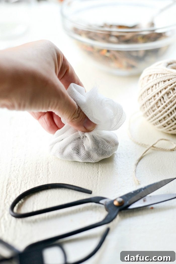 Handcrafted Mulling Spice Sachets 12 Folding the shorter sides of the cheesecloth together over the spices