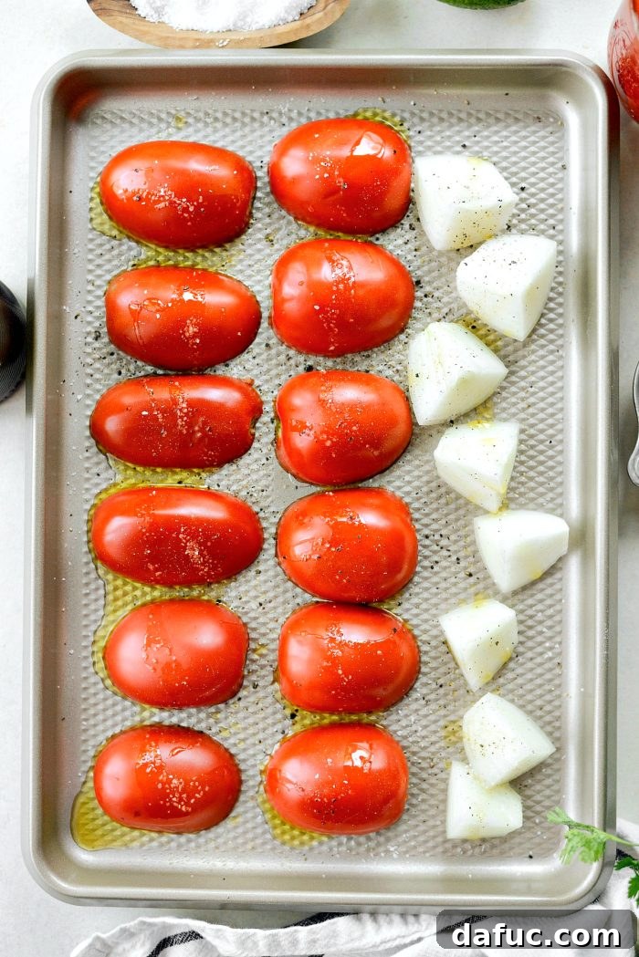 Fiery Chipotle Pepita Crunch 6 romas and onions on roasting pan