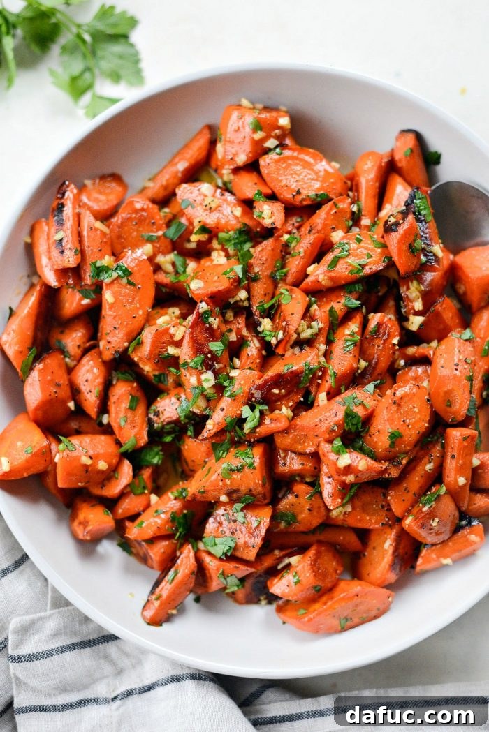 Perfectly roasted carrots coated in glossy garlic butter and fresh parsley, ready to serve as an easy side dish.