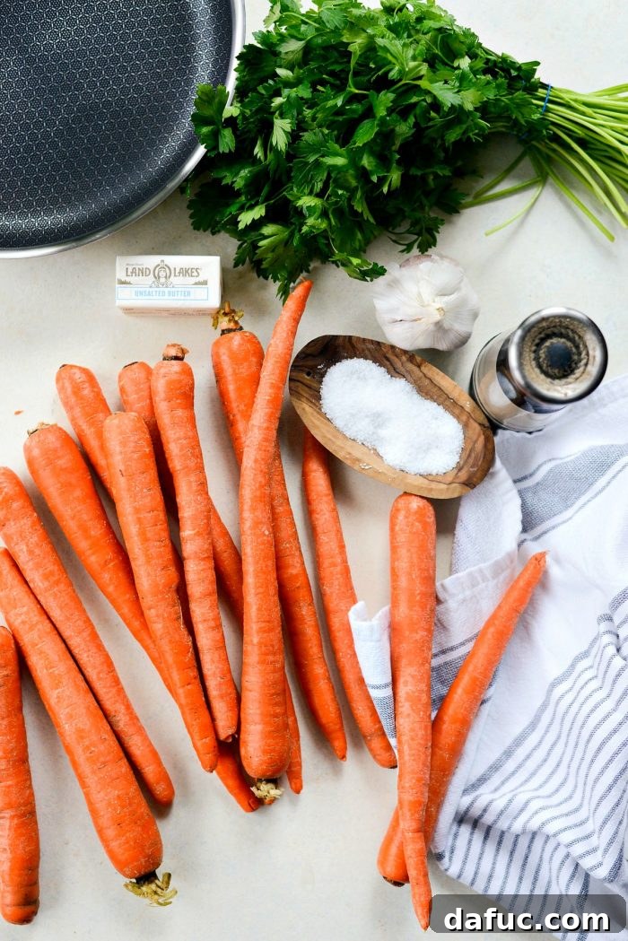 Close-up of garlic butter roasted carrots in a skillet, showcasing their vibrant color and tender texture.