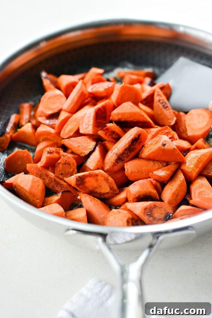 Close-up of the fragrant garlic butter mixture in the skillet, ready for the roasted carrots.