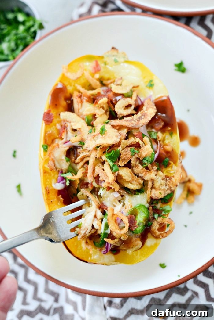 Delicious Chicken Bacon Jalapeño Spaghetti Squash - a healthy and flavorful stuffed squash recipe with BBQ chicken, crispy bacon, and spicy jalapeño. Perfect for dinner!