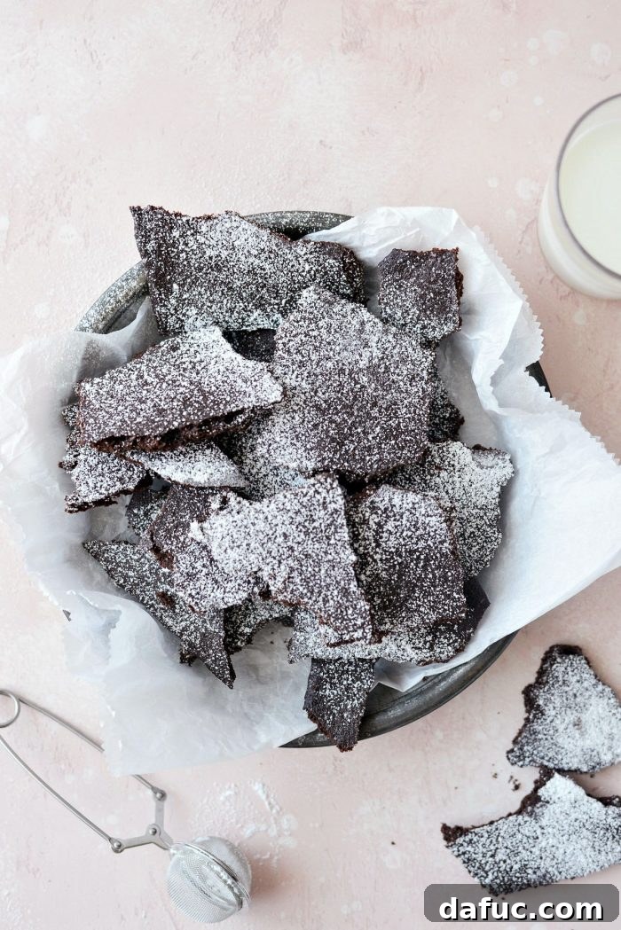 Gourmet Brownie Crisps 13 Dusting homemade brownie brittle with powdered sugar before serving