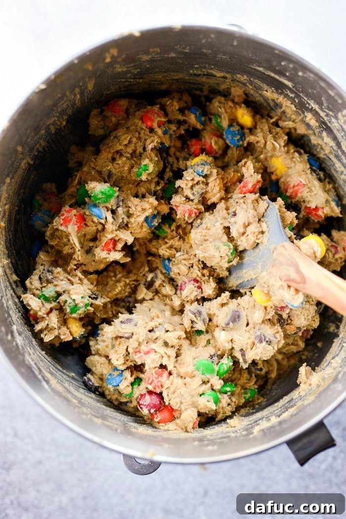 Mixing M&Ms into the cookie dough by hand with a spatula