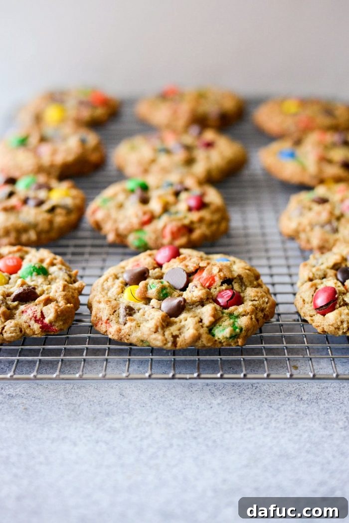 Warm Monster Cookies cooling on a wire rack