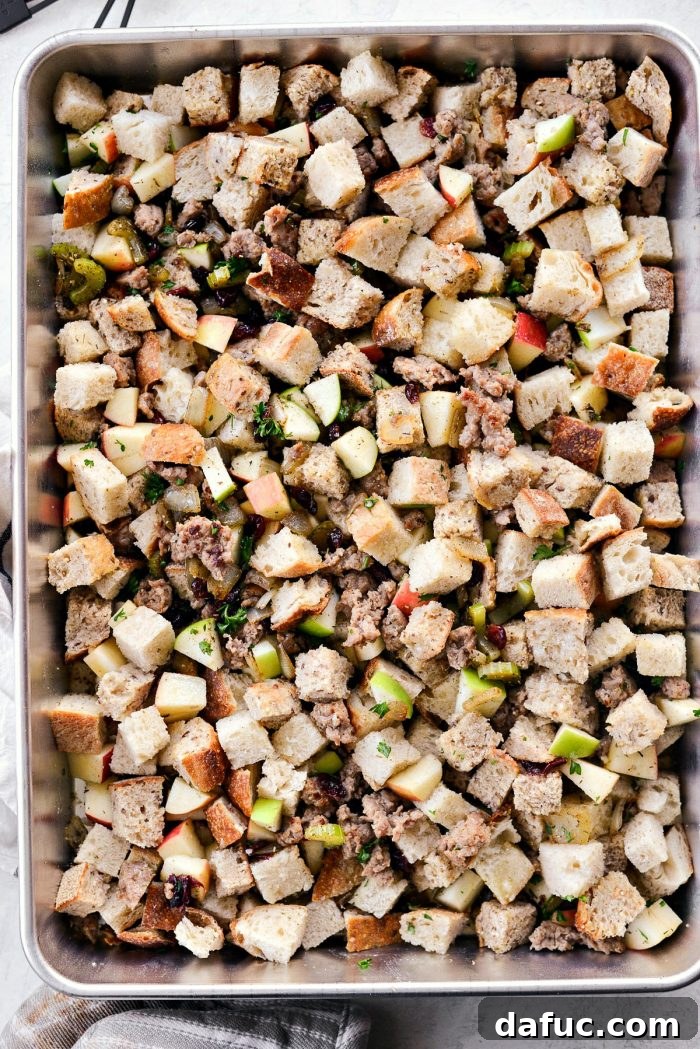 Tossing stuffing with turkey stock and melted butter.